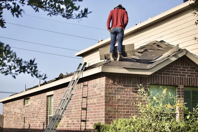 Professional roofer working on a residential roof in Hufsmith